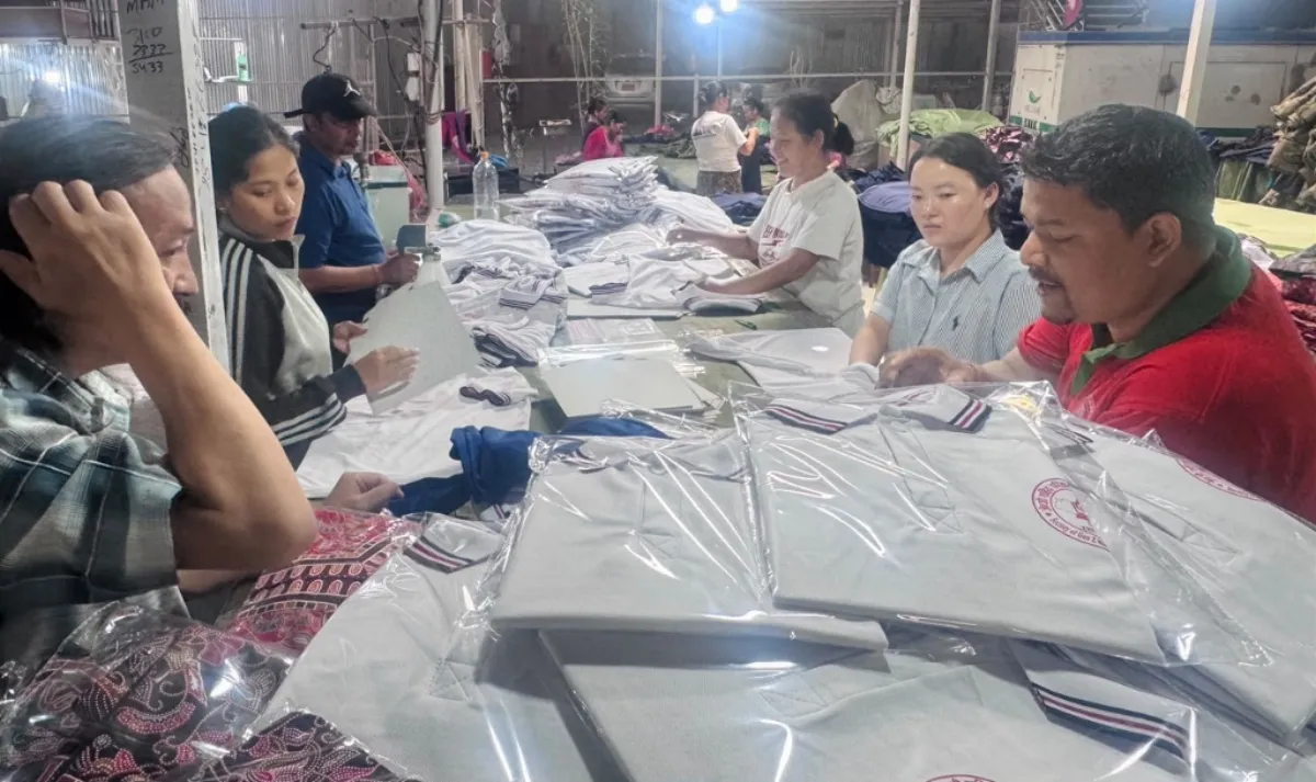 Quality control and packing workers inspecting and poly-bagging school uniforms at Pragati Venus Uniform