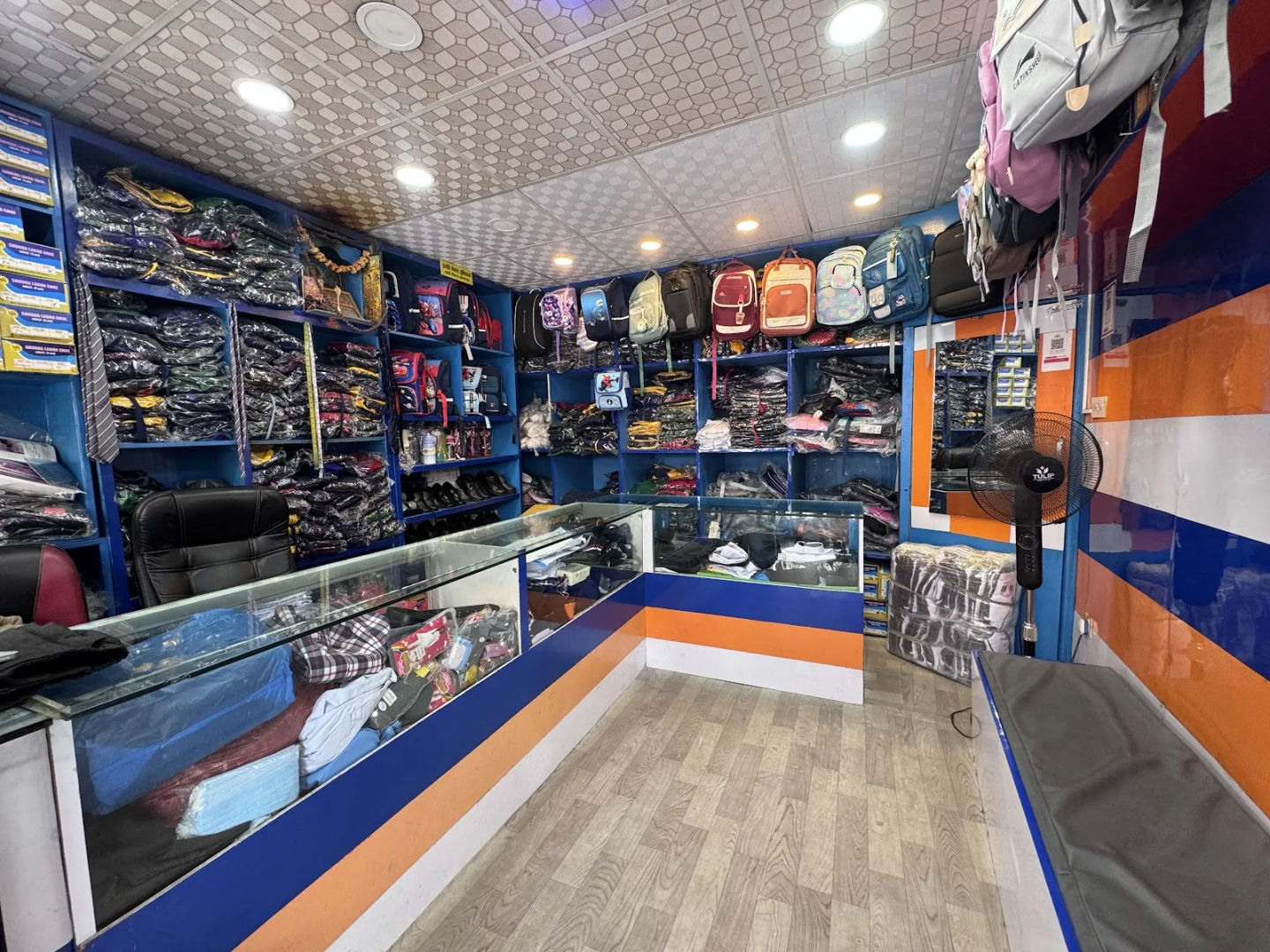 Interior of Pragati Venus Uniform with uniforms, school bags and accessories displayed on shelves